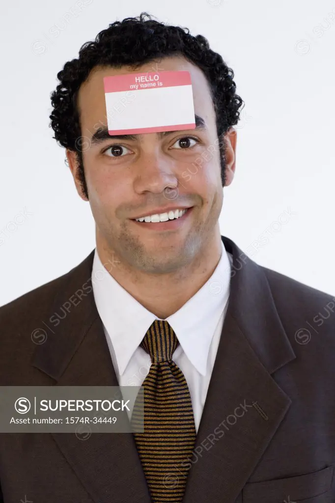 Portrait of a businessman with a name tag on his forehead and smiling