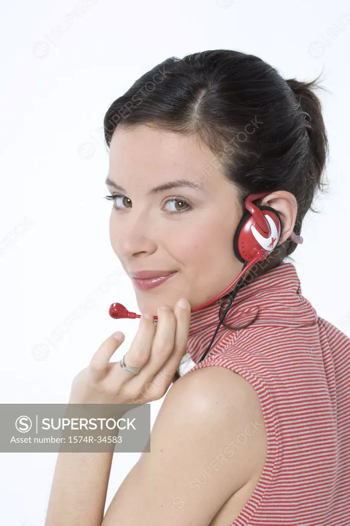Portrait of a female customer service representative wearing a headset and grinning