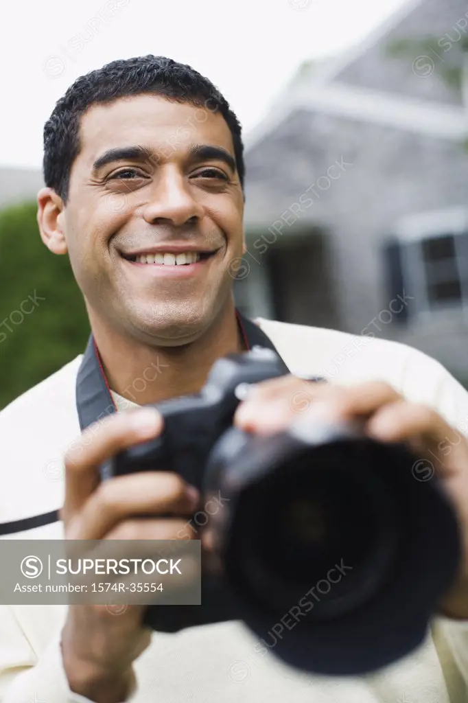 Close-up of a man holding a camera