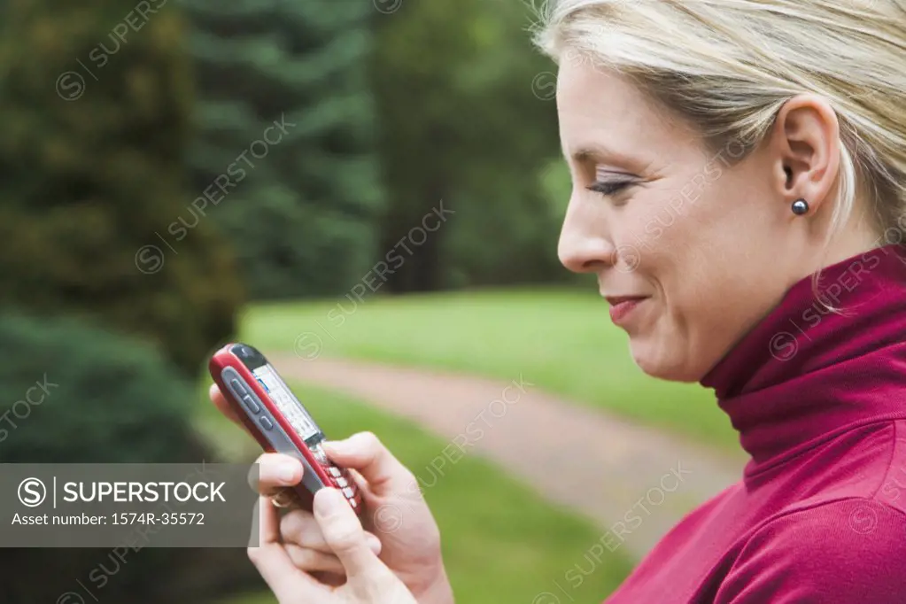 Woman reading text message on mobile phone