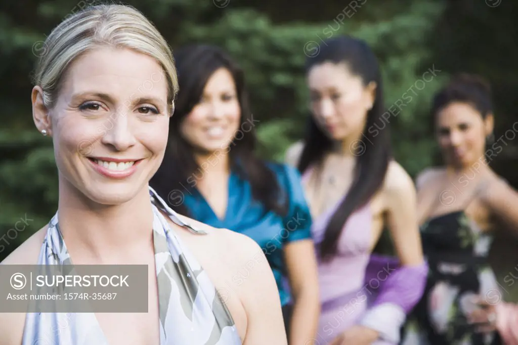 Portrait of happy woman smiling with friends in background