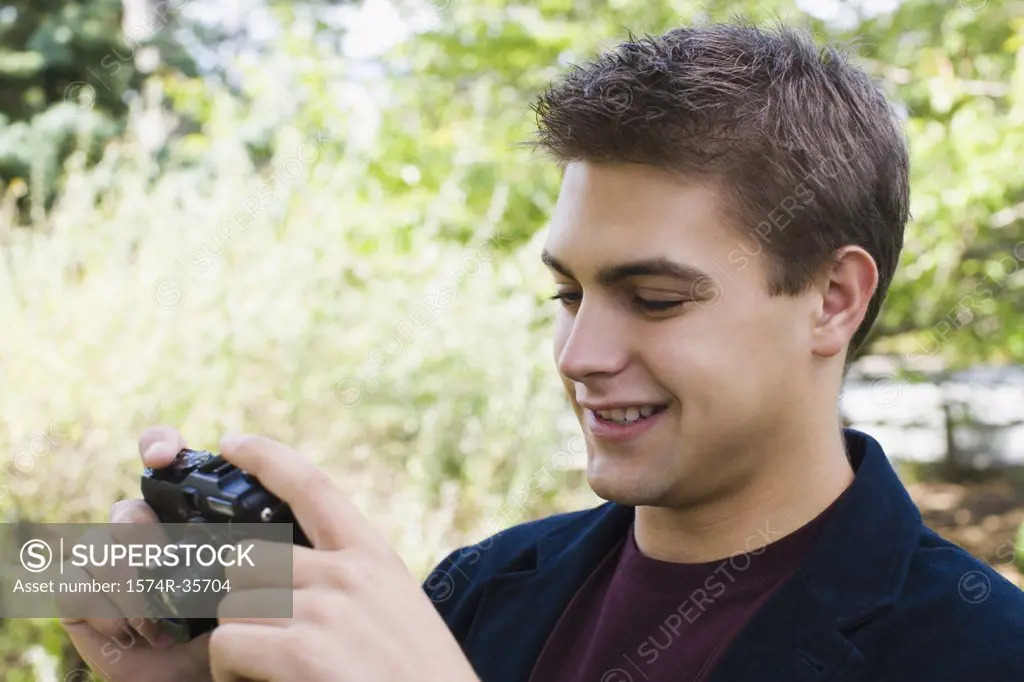Close-up of man taking picture with camera