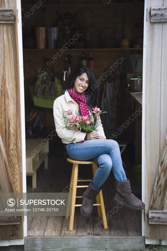 Woman holding bouquet of flowers and smiling