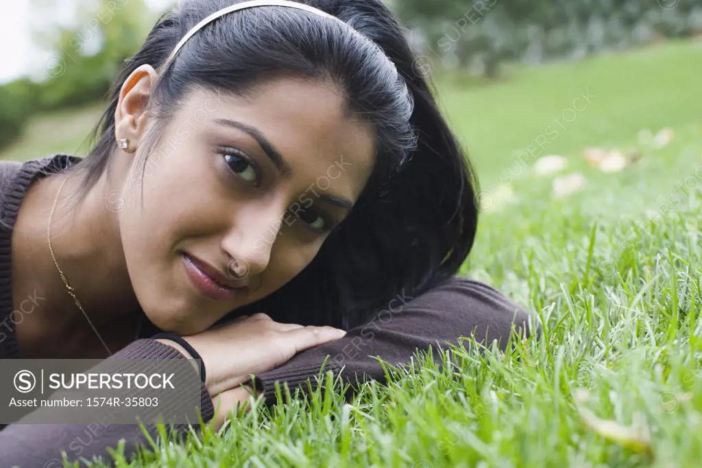 Portrait of woman lying in lawn