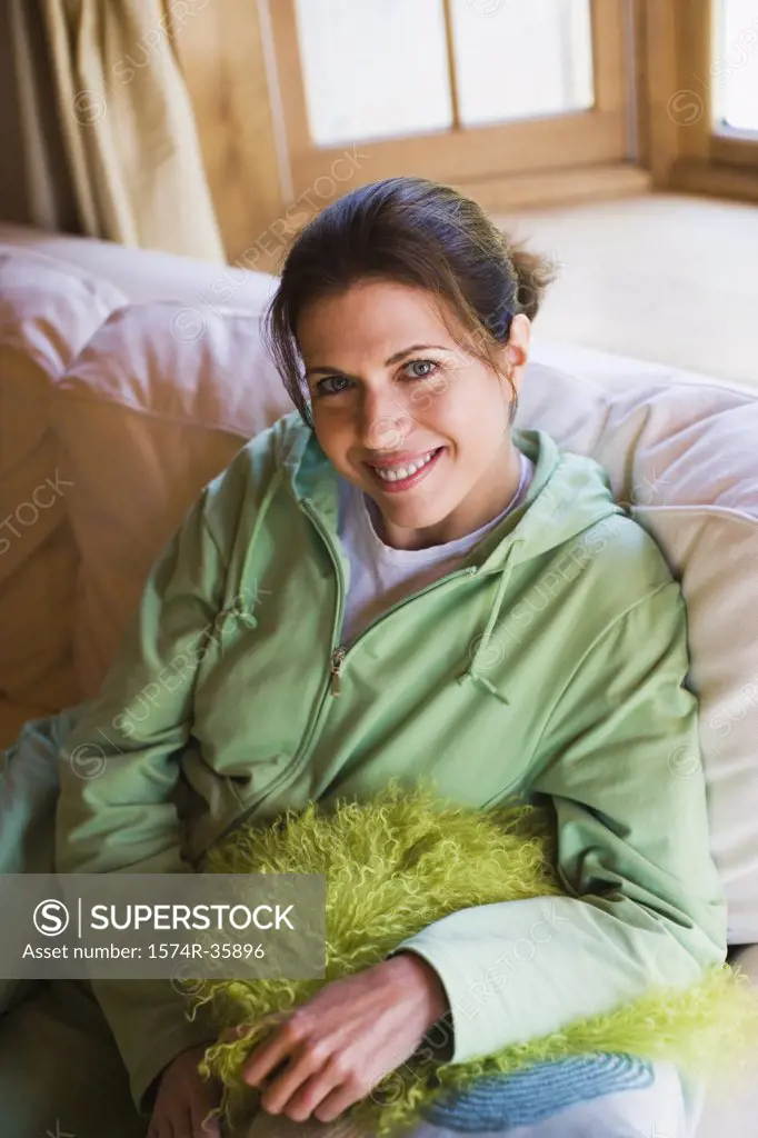 Happy woman sitting on a couch and smiling