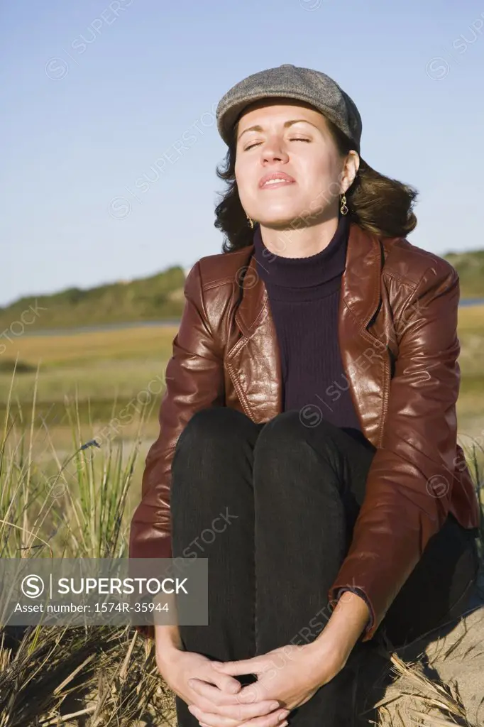 Woman sitting with her eyes closed