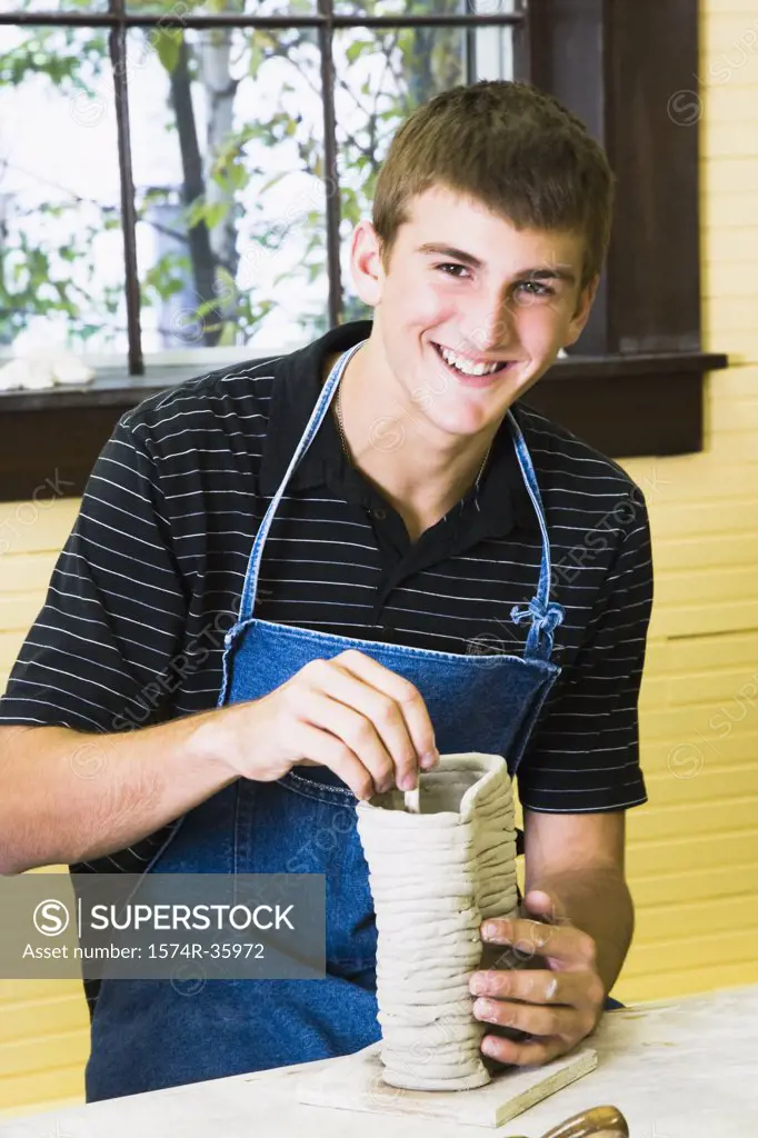 Portrait of a teenage boy making a pottery