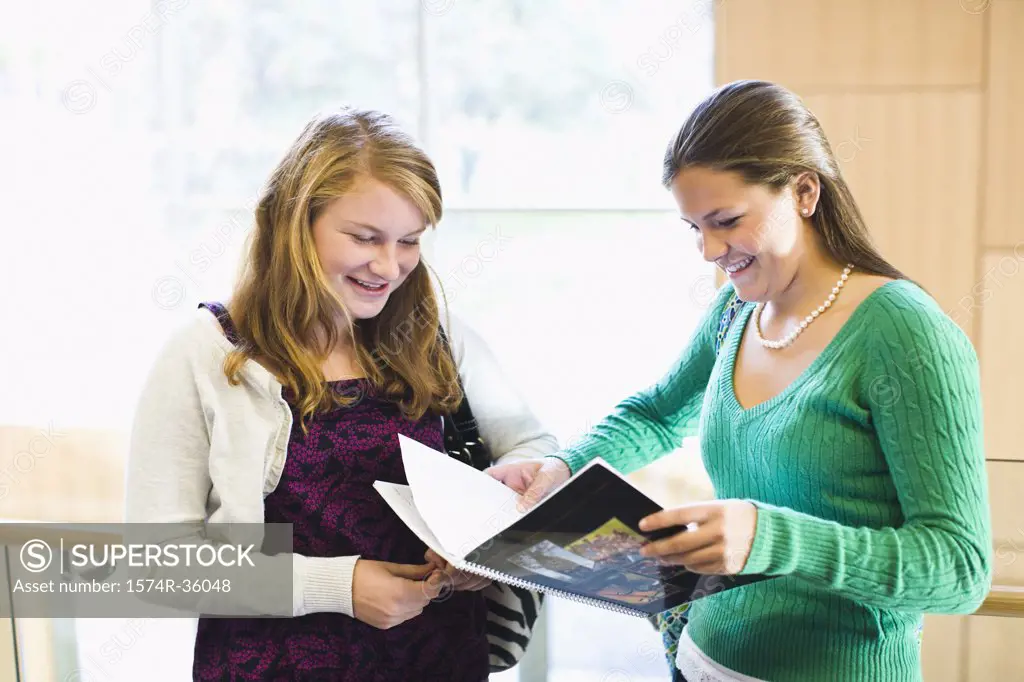 Two students reading a book 