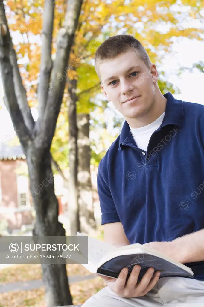 Portrait of a student holding a book