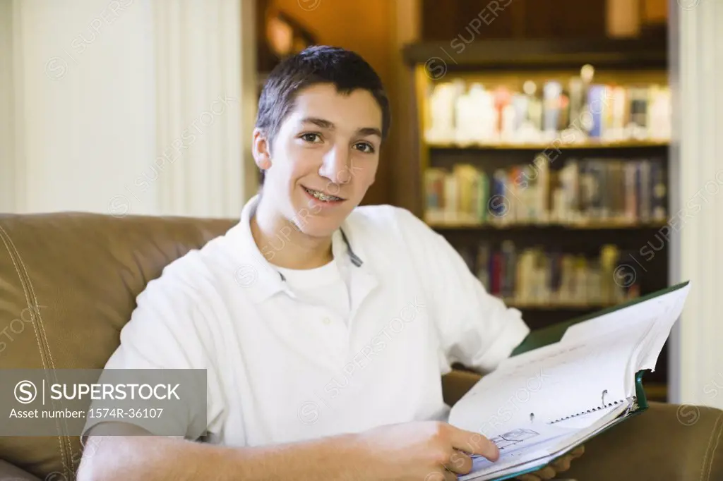 Portrait of a student holding a spiral notebook