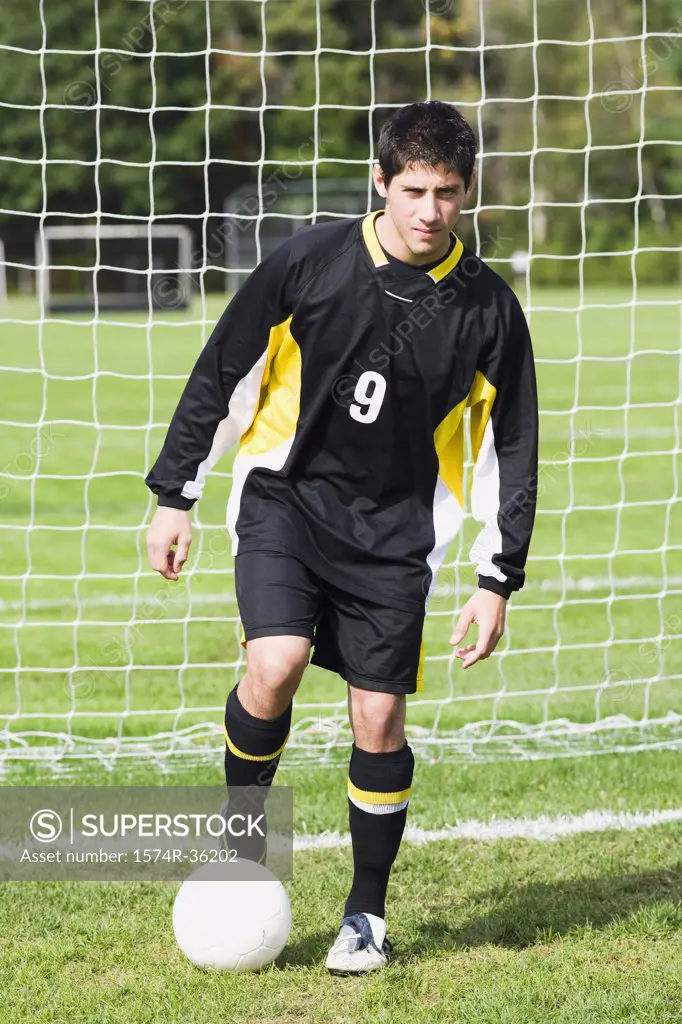 Portrait of a soccer player playing with a soccer ball