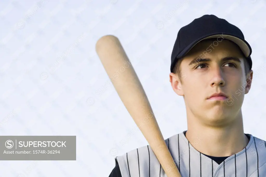 Close-up of a teenage boy holding a baseball bat