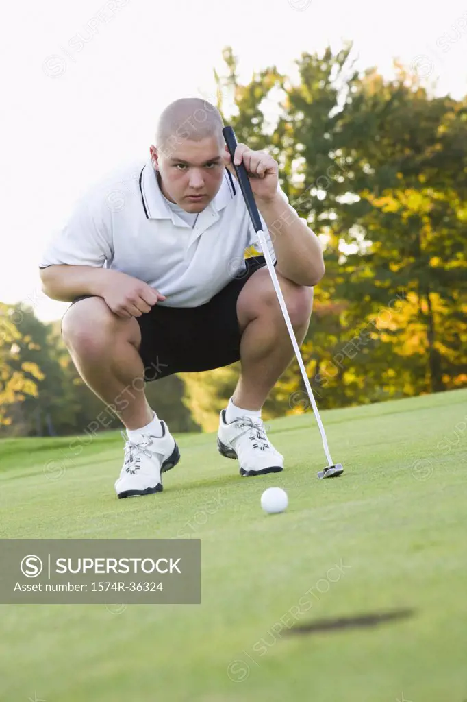 Man looking at hole in a golf course