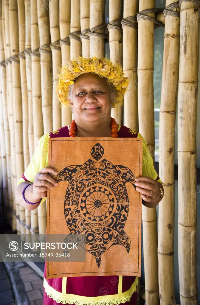 Portrait of a woman holding a wall hanging, Papeete, Tahiti, French Polynesia