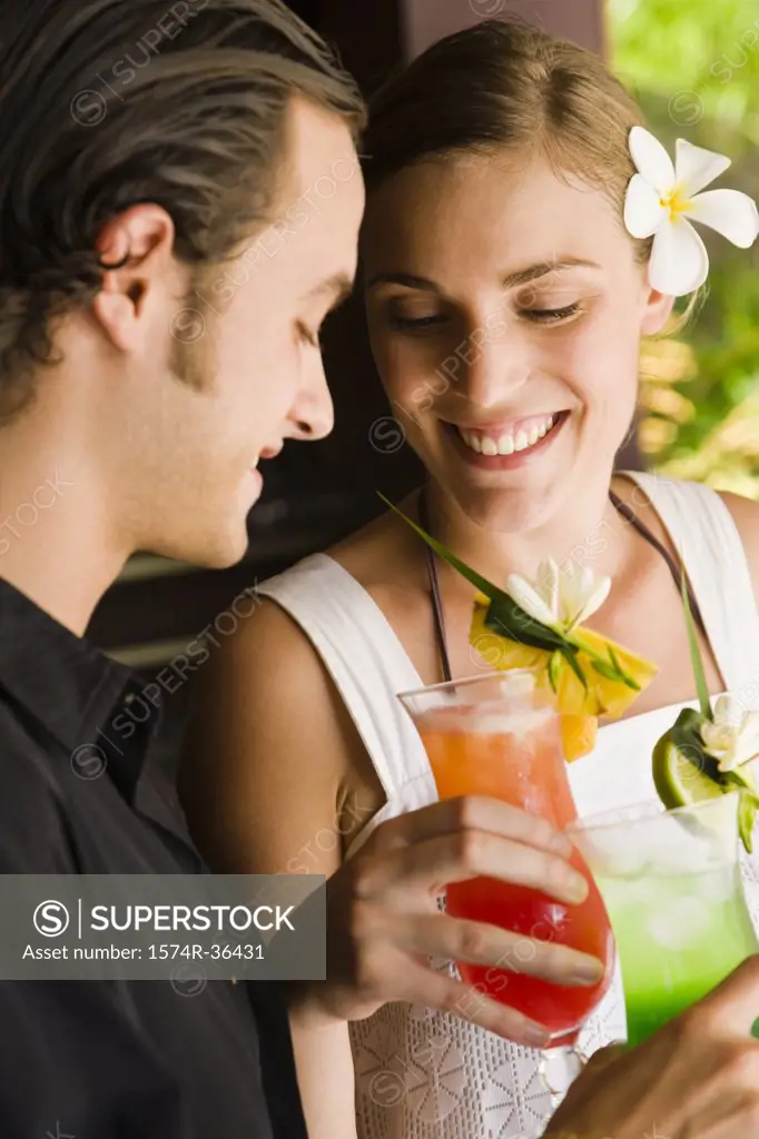 Close-up of a couple enjoying cocktail, Papeete, Tahiti, French Polynesia