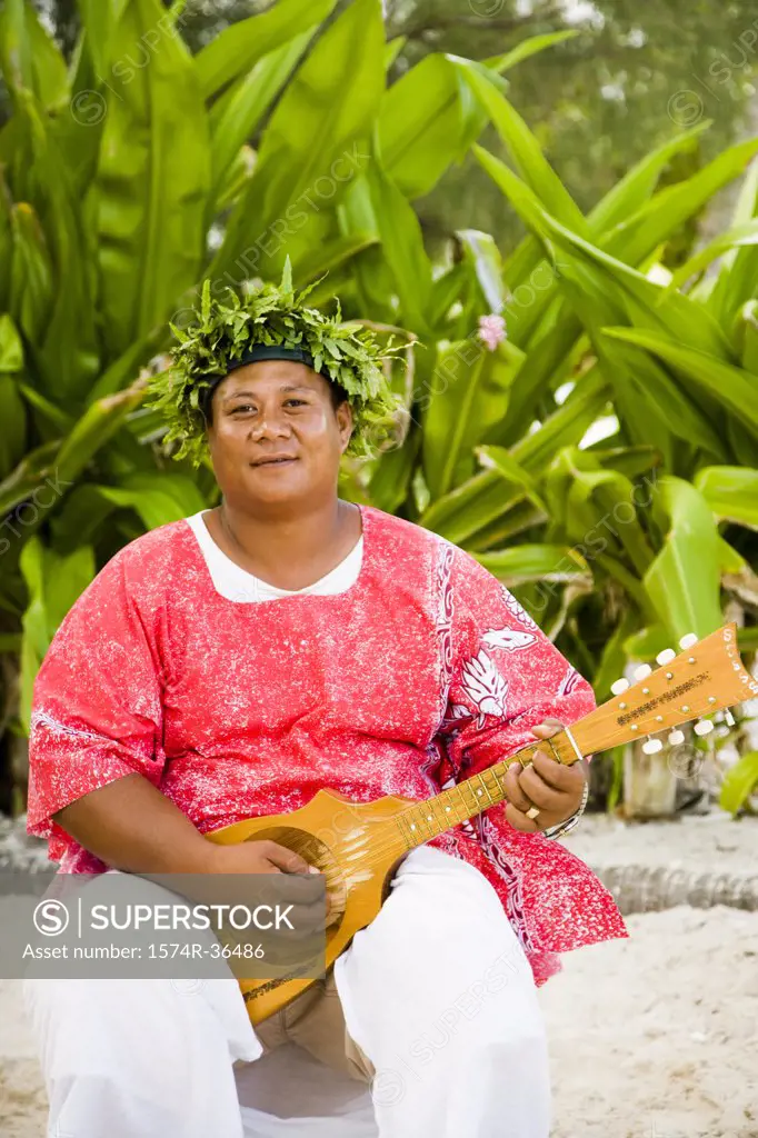 Portrait of a man playing a mandolin, Tahaa, Tahiti, French Polynesia