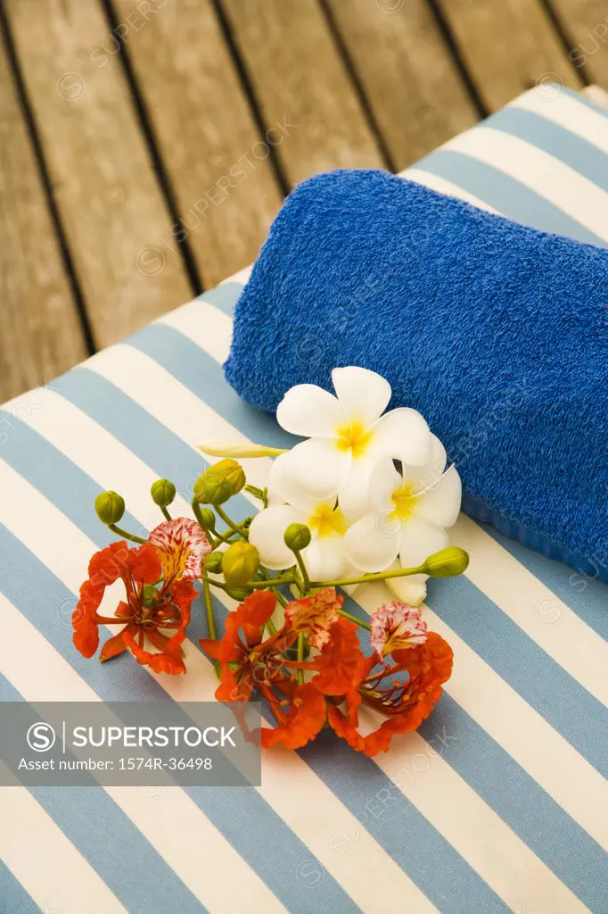 Flowers with towel on a lounge chair in a spa resort, Bora Bora, Tahiti, French Polynesia