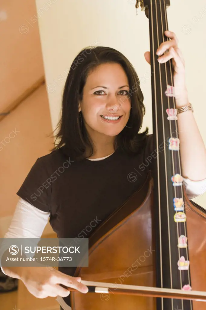 Woman playing a mandolin and smiling