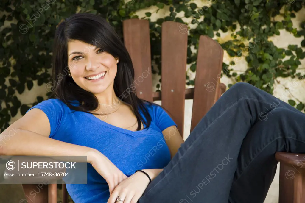 Portrait of a woman sitting on a chair and smiling