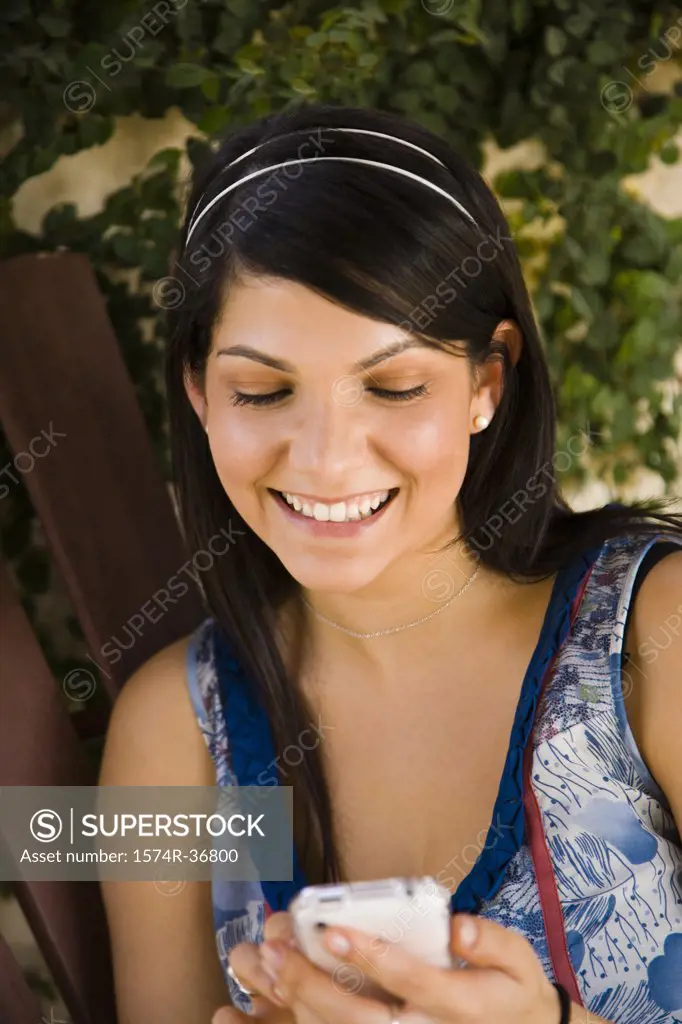 Woman text messaging on a mobile phone