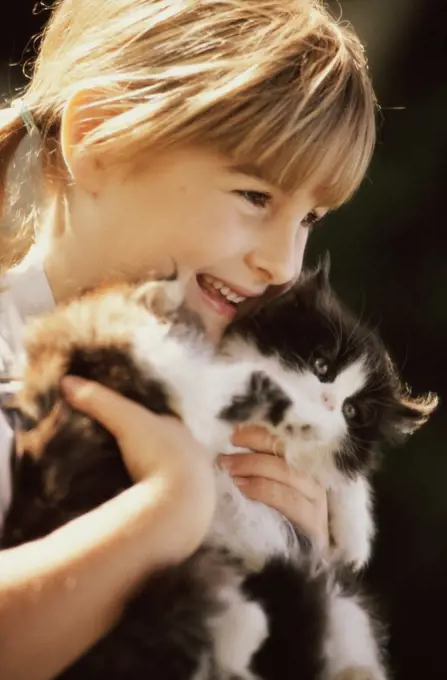 Close-up of a girl holding cats