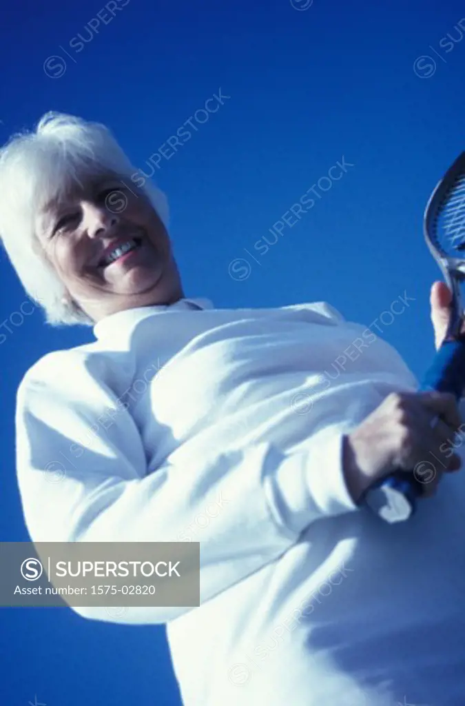 Mature woman playing tennis