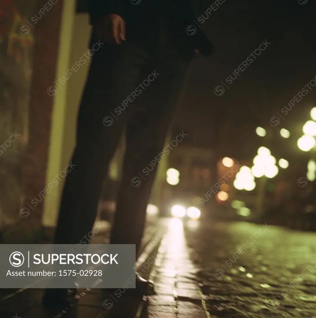 Man standing on cobblestone street
