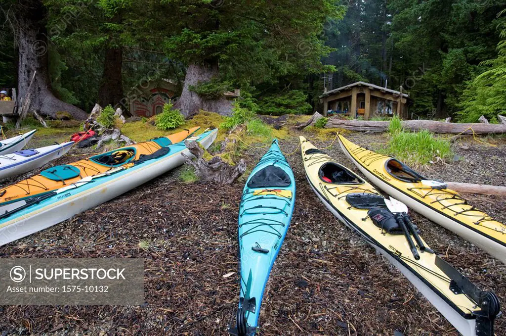 Canada, BC, Haida Gwaii Queen Charlotte Islands, Gwaii Haanas National Park. Windy Bay hlk´yah Llnagaay. Kayaks pulled up on the beach at Haida Herati...