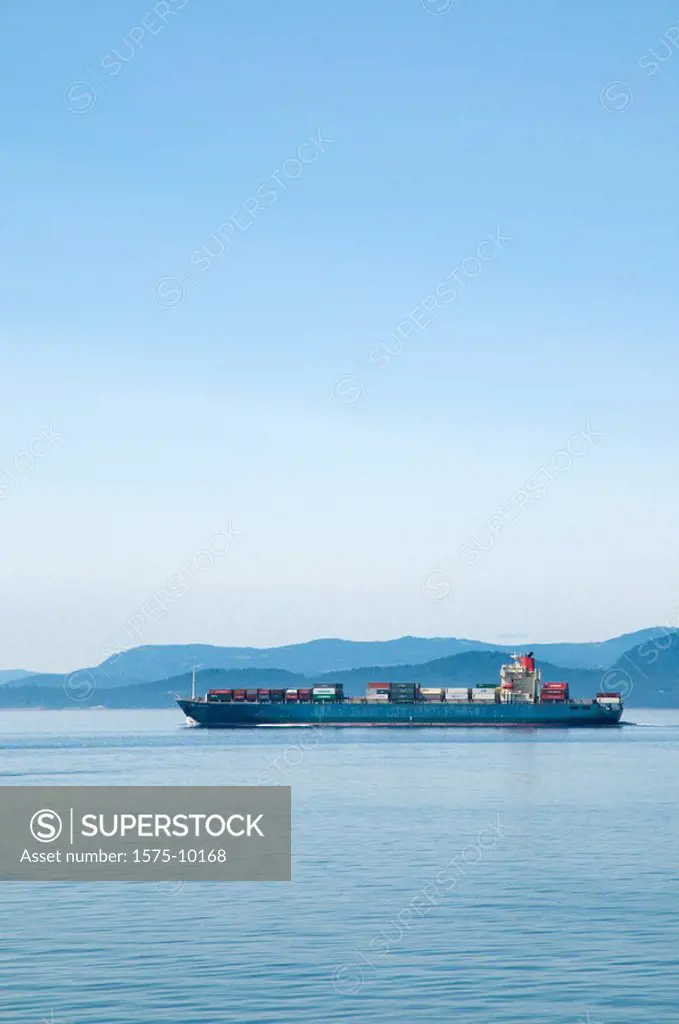 Canada, BC, Gulf Islands. Georgia Straight. Container ship moving between Vancouver Island and the mainland