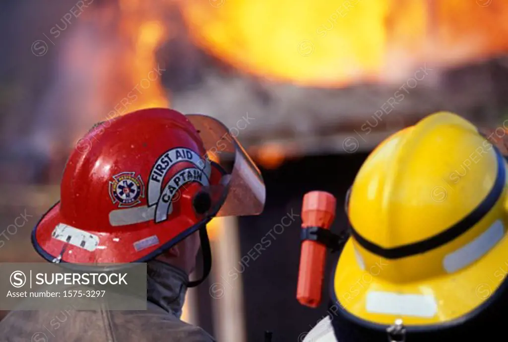 Close up of firefighters helmets, house fire