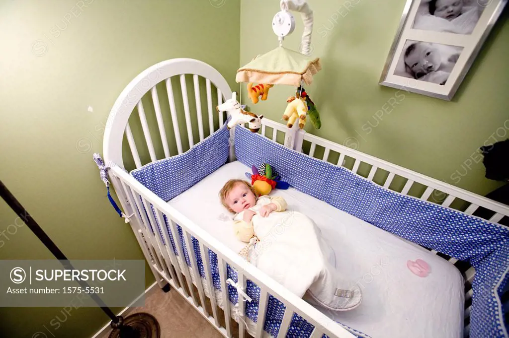Wide shot of baby in crib