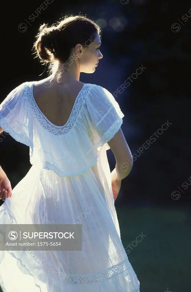 woman dancing in white summer dress