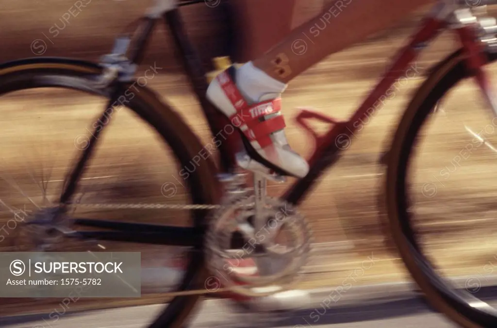Close up of wheels/frame of a bicycle, blurry
