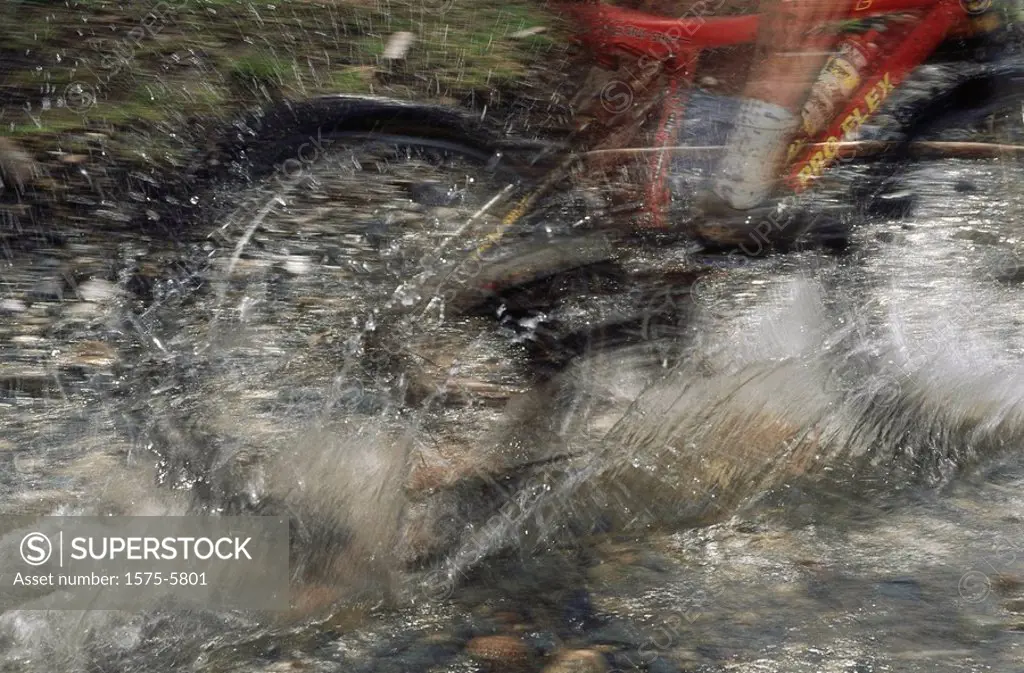 Mountain bike going through puddle, blur