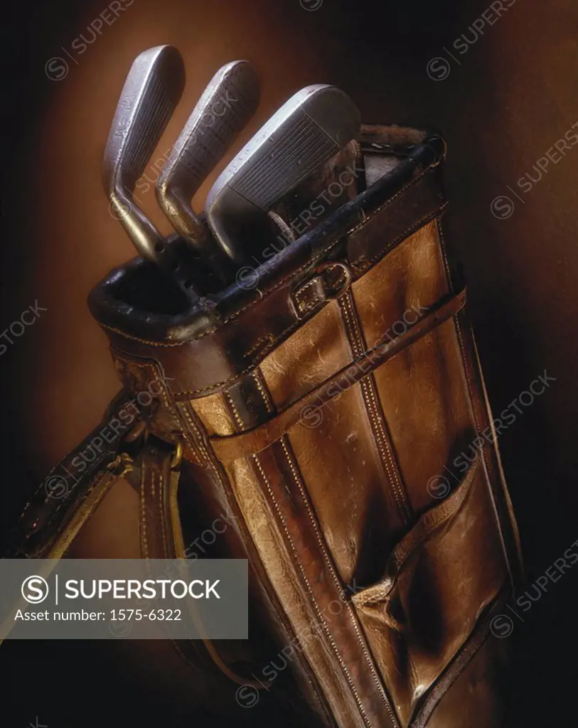 Close up of antique golf clubs and bag