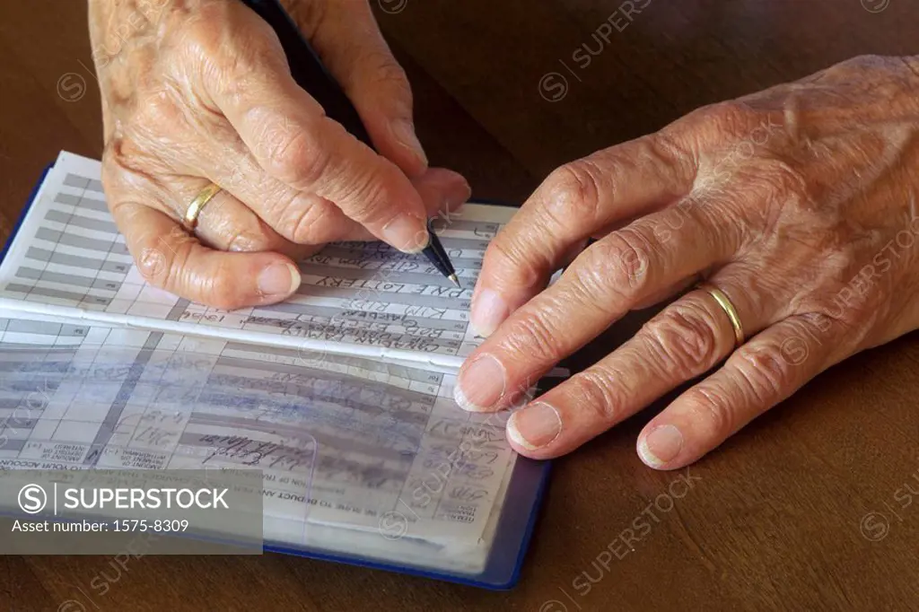 Senior woman writing bills