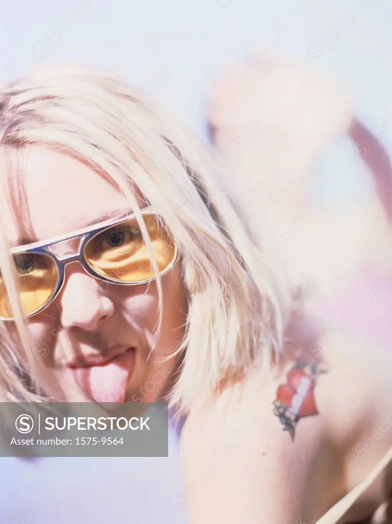 Blonde woman sticking out tongue