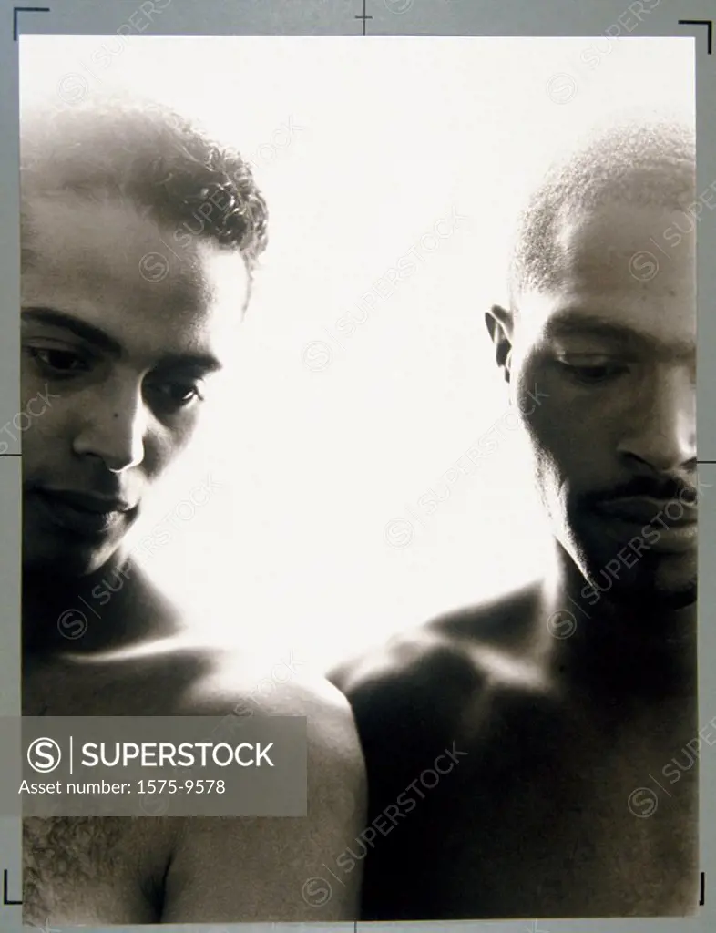 Two men in portrait looking down