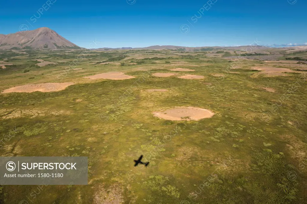 Shadow of a flying aircraft in field, Asbyrgi, Iceland