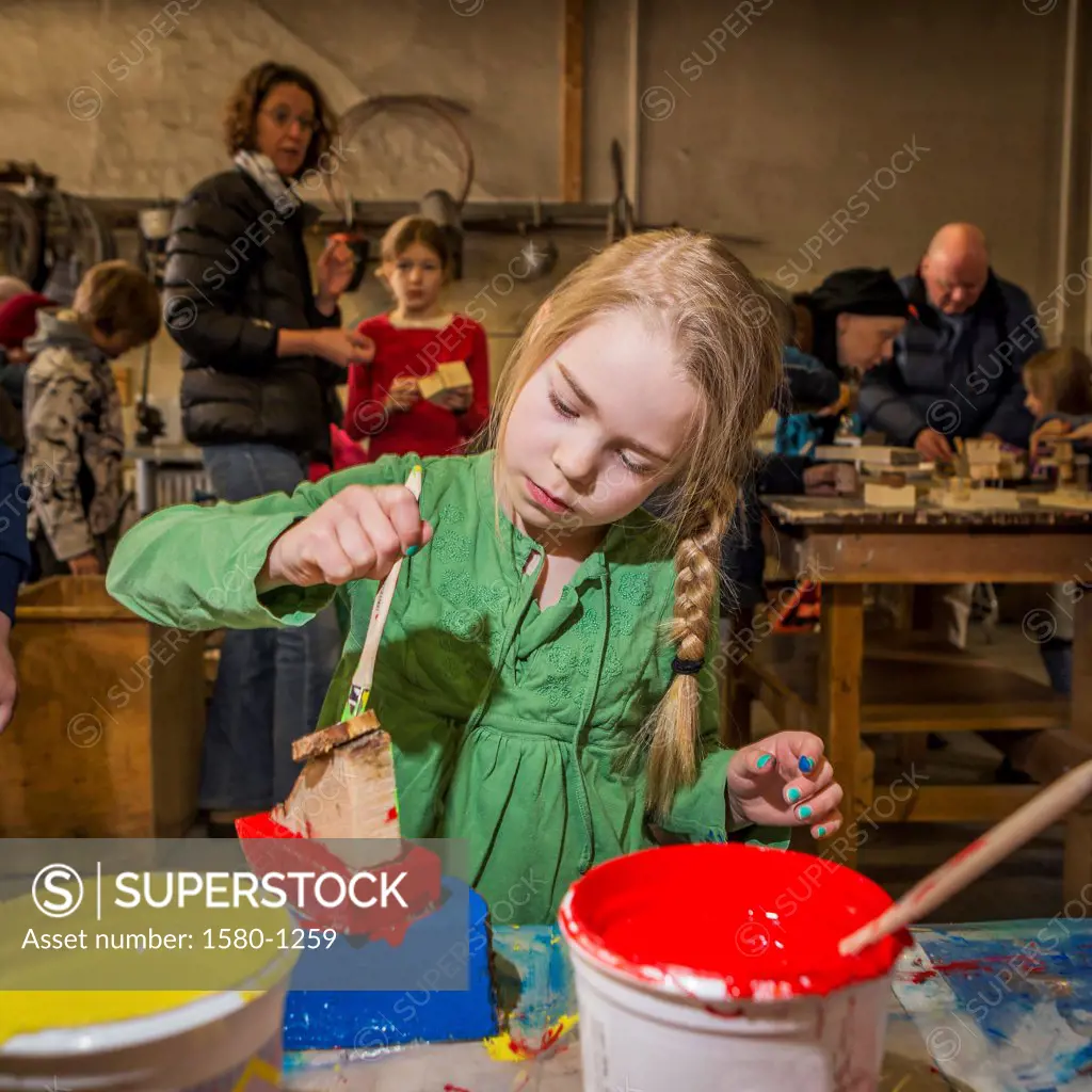 Young girl painting during the Children's Cultural Festival, Reykjavik, Iceland
