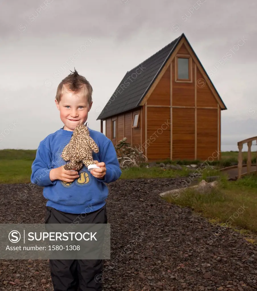 Young boy holding his stuffed toy, Eskifjordur, Iceland