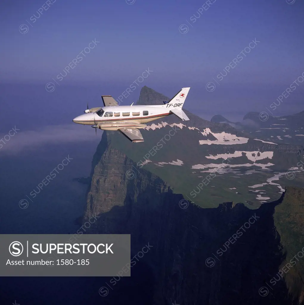 Private airplane in flight over the sea, Hornbjarg Cliffs, Iceland