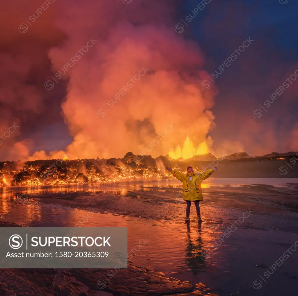 Woman standing by glowing lava. August 29, 2014, a fissure eruption started in Holuhraun at the northern end of a magma intrusion, which had moved progressively north, from the Bardarbunga volcano. Bardarbunga is a stratovolcano located under Vatnajokull, Icelands most extensive glacier. Picture date- Sept 2, 2014