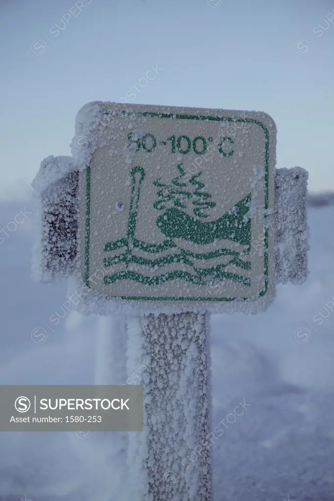 Close-up of a warning sign covered with snow, Iceland