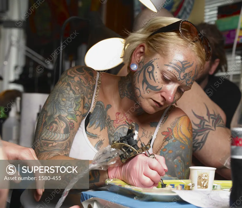 Iceland, Reykjavik, Female tattoo artist in studio