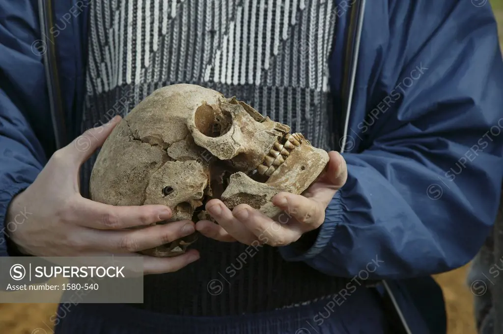Iceland, Archaeologist Holding Viking Era Skull
