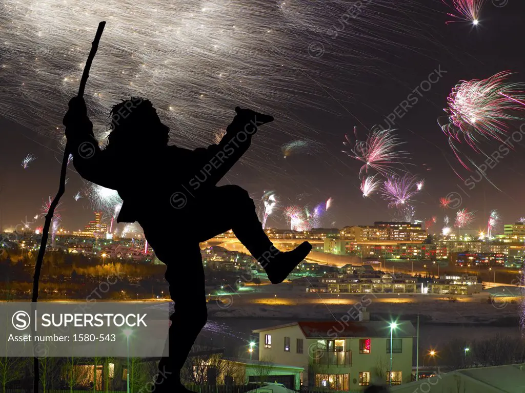 Iceland, Reykjavik, New Years Eve, Silhouette of Yule Lad (Santa Claus) with firework display in background