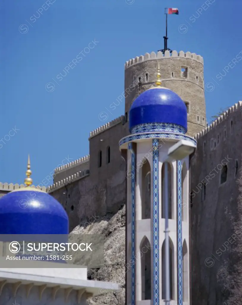 Low angle view of a mosque in front of a fort, Khor Mosque, Mirani Fort, Muscat, Oman