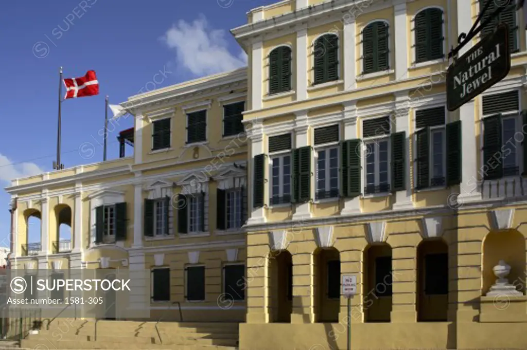 Low angle view of a flag fluttering on a government building, Government House, Christiansted, St. Croix, US Virgin Islands