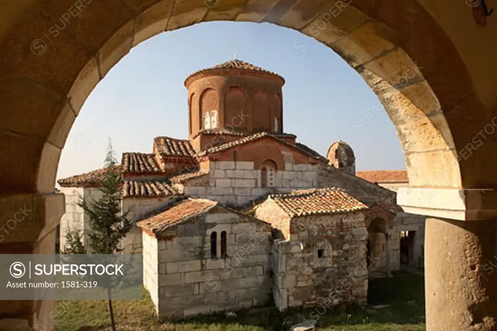 Church viewed through a window, Apollonia, Albania
